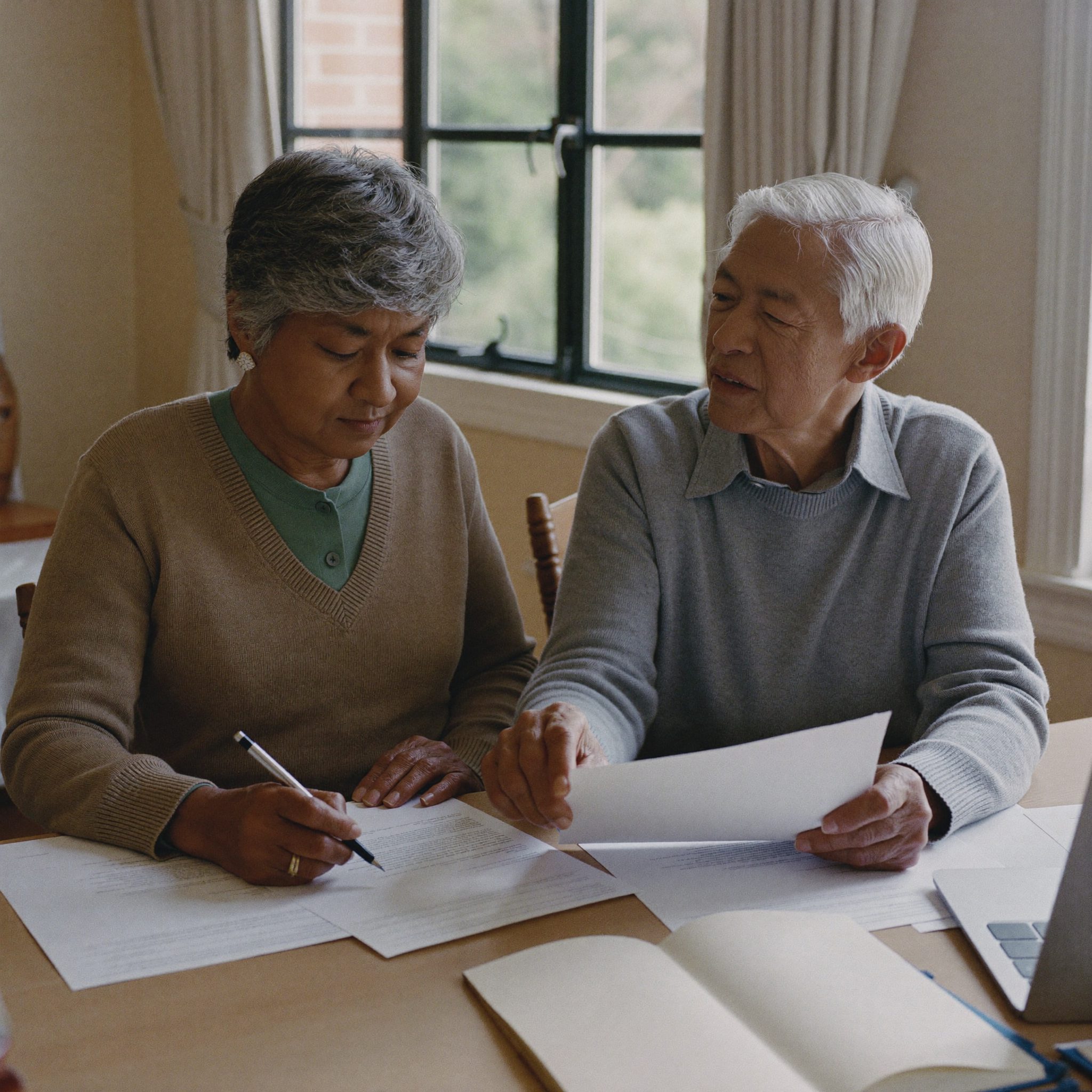 Couple reviewing retirement planning documents with an advisor